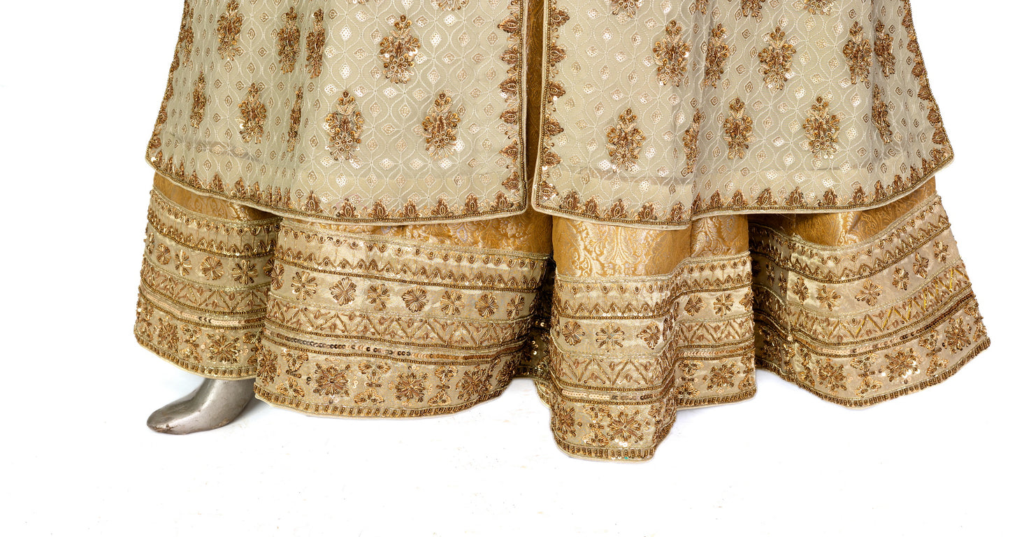 Olive green and gold Pakistani bridal Anarkali dress by MariamRaj, featuring gold and copper handwork, gold lehenga, and net dupatta – custom stitched for UK weddings.