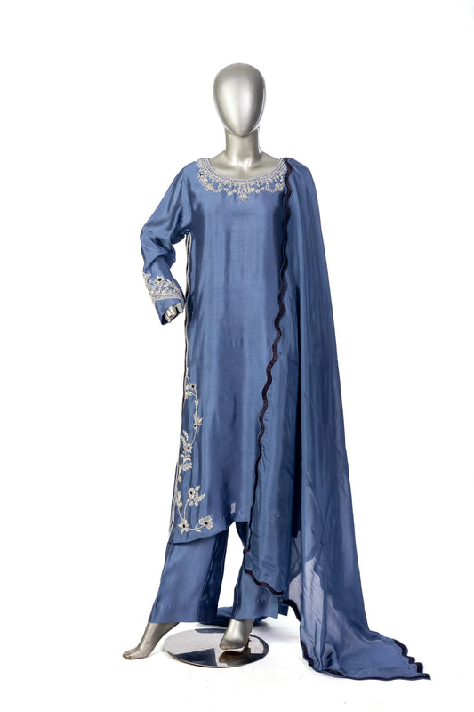 Abeera – Steel Blue Sheesha Silk embroidered suit with medium silk dupatta & straight trousers by MariamRaj. Perfect festive wear.