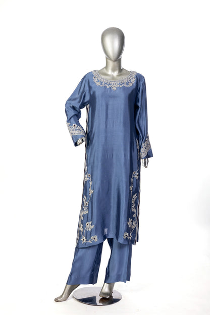 Abeera – Steel Blue Sheesha Silk embroidered suit with medium silk dupatta & straight trousers by MariamRaj. Perfect festive wear.