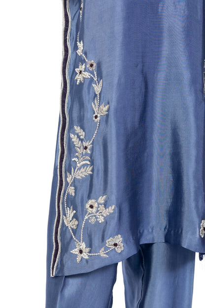 Abeera – Steel Blue Sheesha Silk embroidered suit with medium silk dupatta & straight trousers by MariamRaj. Perfect festive wear.