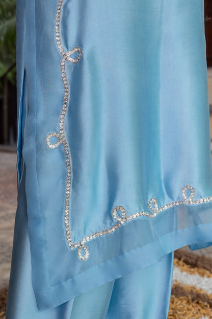 Sky blue Pakistani sheesha silk suit with vertical neckline embroidery, sleeve and side panel work, and pearl-detailed organza dupatta by MariamRaj for festive wear in the USA.