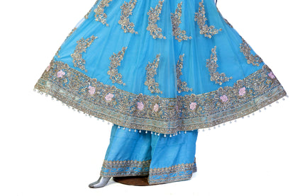Sky-blue Pakistani Anarkali dress by MariamRaj with floral embroidery, sharara pants, and net dupatta – perfect for weddings and occasions in the USA.