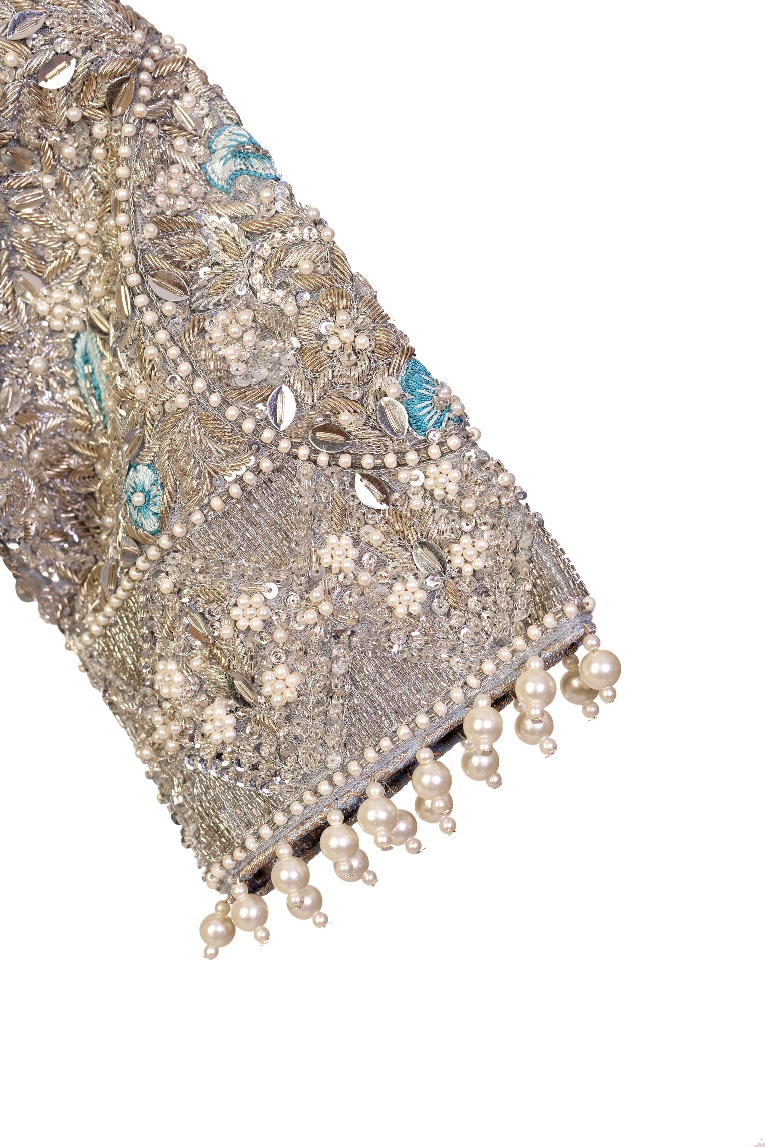 Elsa – Ice blue Pakistani bridal lehenga by MariamRaj featuring a hand-embroidered raw silk blouse with tassels, net lehenga with intricate motifs, and a fully embellished net organza dupatta. Custom stitched for Pakistani brides in USA and UK.