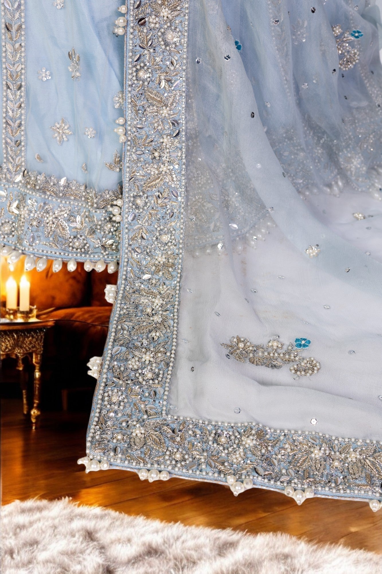 Elsa – Ice blue Pakistani bridal lehenga by MariamRaj featuring a hand-embroidered raw silk blouse with tassels, net lehenga with intricate motifs, and a fully embellished net organza dupatta. Custom stitched for Pakistani brides in USA and UK.