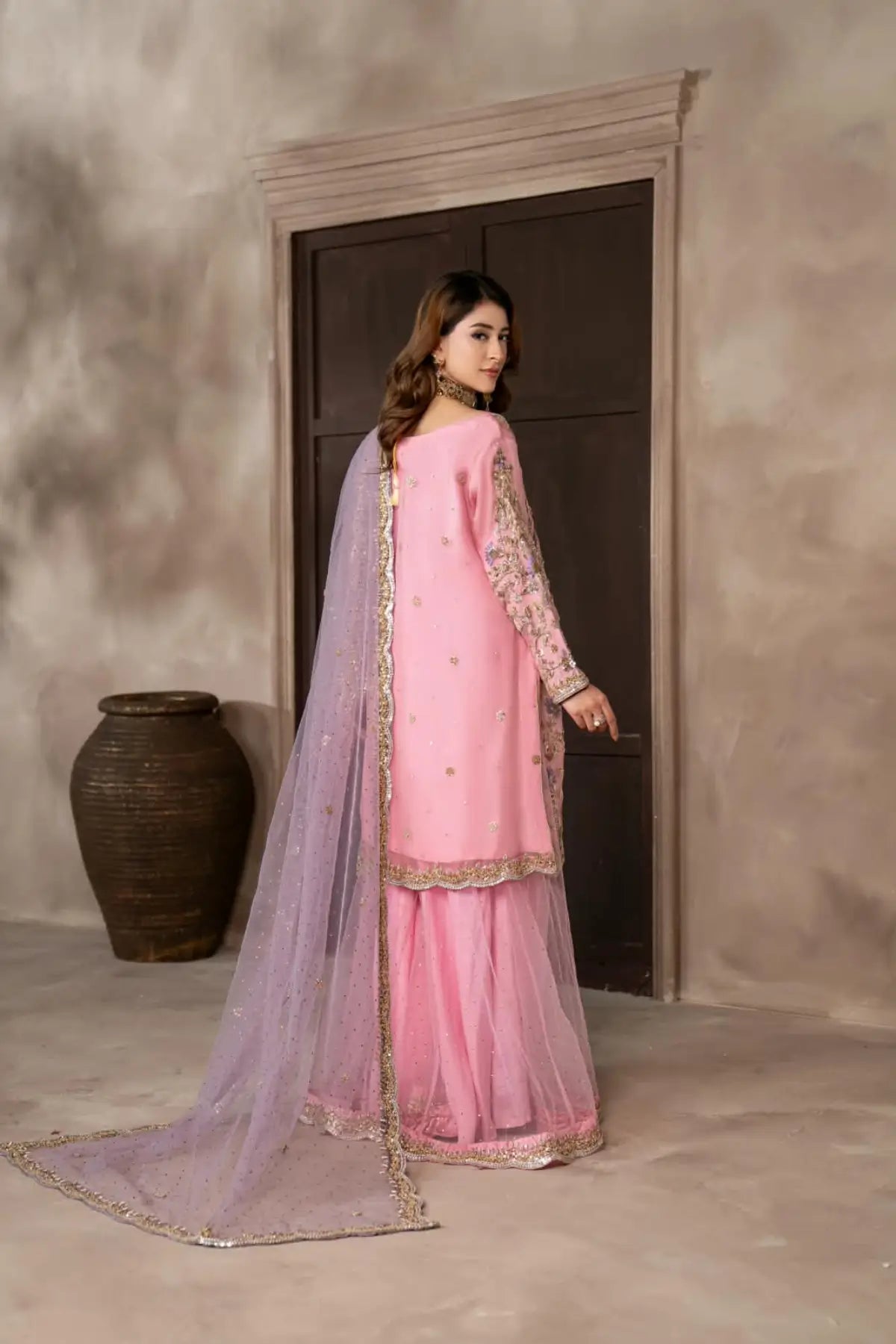 Mahgul powder pink hand embellished organza wedding suit with Kamdani net sharara and lavender net dupatta by MariamRaj