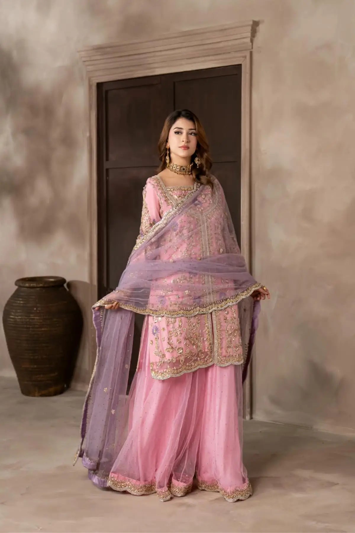 Mahgul powder pink hand embellished organza wedding suit with Kamdani net sharara and lavender net dupatta by MariamRaj