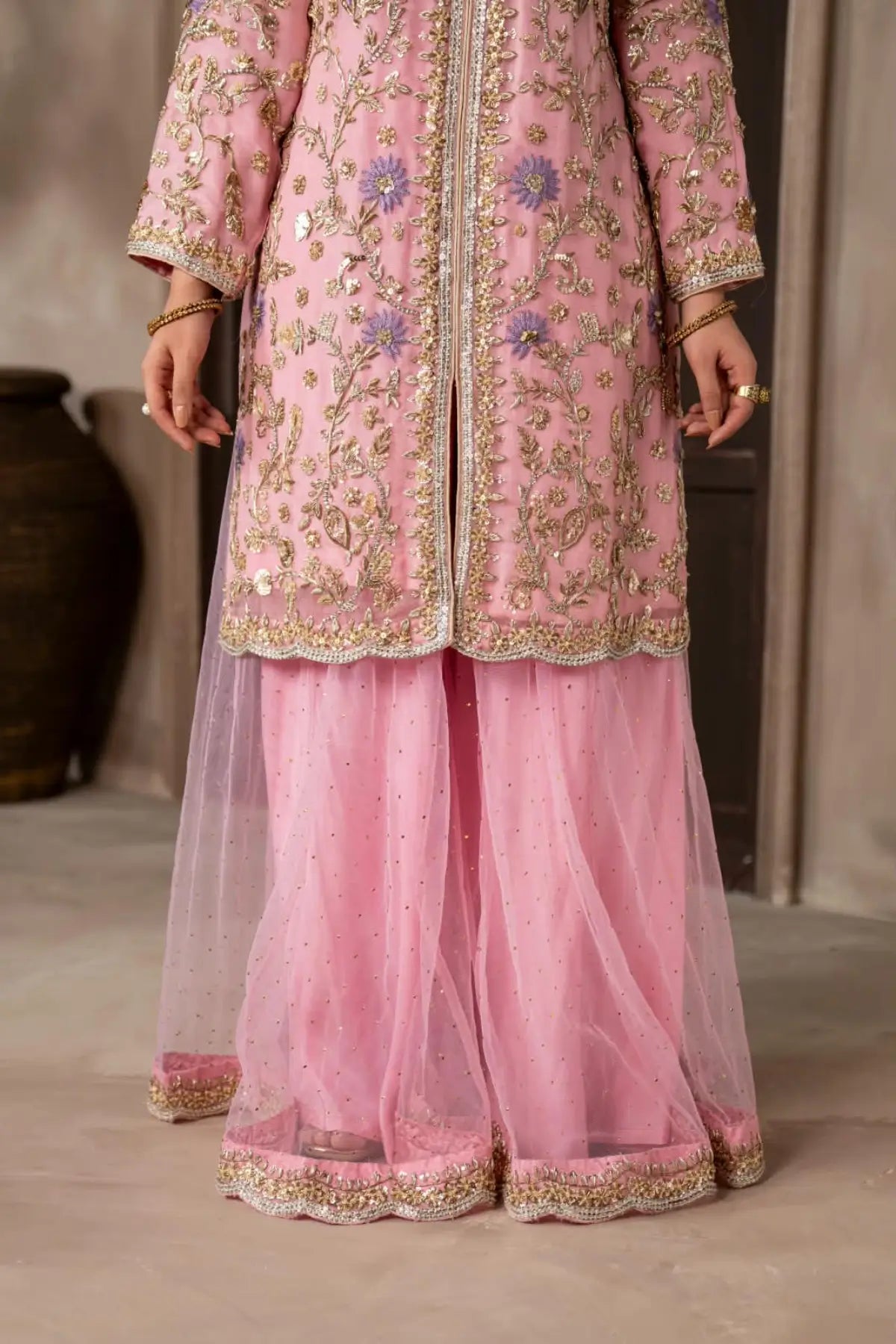 Mahgul powder pink hand embellished organza wedding suit with Kamdani net sharara and lavender net dupatta by MariamRaj