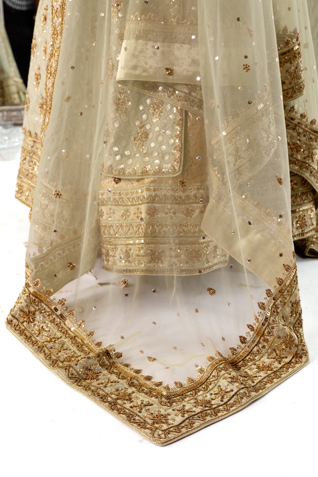 Olive green and gold Pakistani bridal Anarkali dress by MariamRaj, featuring gold and copper handwork, gold lehenga, and net dupatta – custom stitched for UK weddings.