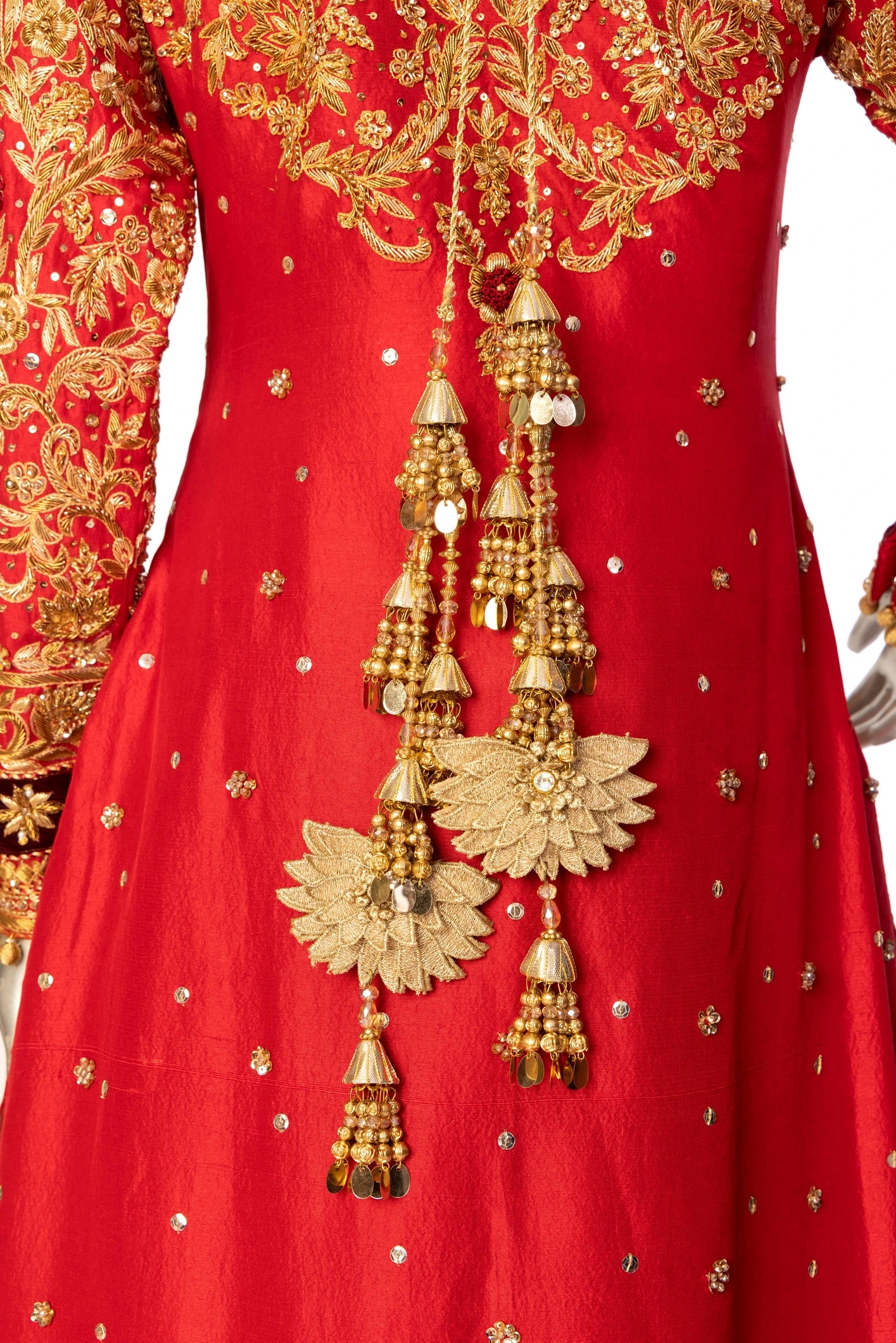 Red bridal lehenga outfit by MariamRaj featuring embroidered kameez, gold-detailed lehenga, and net dupatta with golden ball edging – ideal for Pakistani barat weddings.