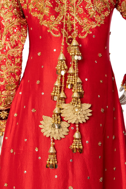 Red bridal lehenga outfit by MariamRaj featuring embroidered kameez, gold-detailed lehenga, and net dupatta with golden ball edging – ideal for Pakistani barat weddings.