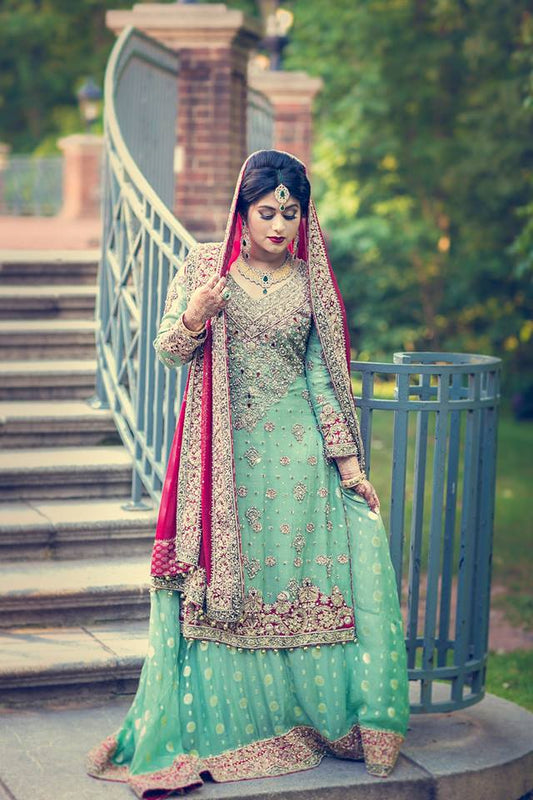 Skyline Charm bridal outfit by MariamRaj featuring mint green embroidered chiffon shirt, embellished lehenga, and deep red dupatta with tassels – custom stitched for Pakistani weddings.