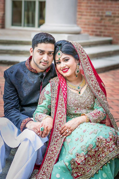 Skyline Charm bridal outfit by MariamRaj featuring mint green embroidered chiffon shirt, embellished lehenga, and deep red dupatta with tassels – custom stitched for Pakistani weddings.

